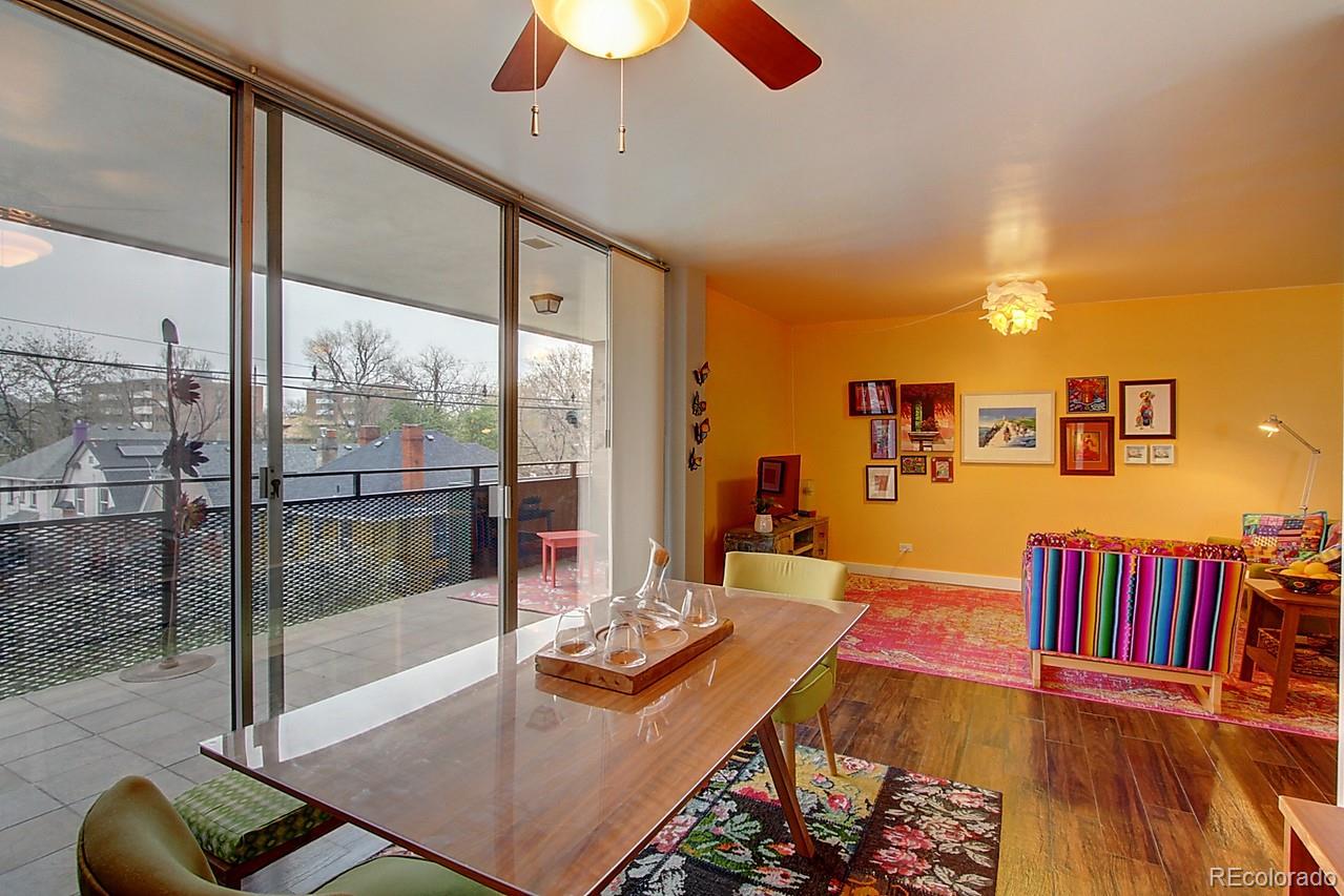 1200 Vine Street, Unit 4B Denver, CO 80206 - Photo 9 of 33 a living room with couch and a flat screen tv