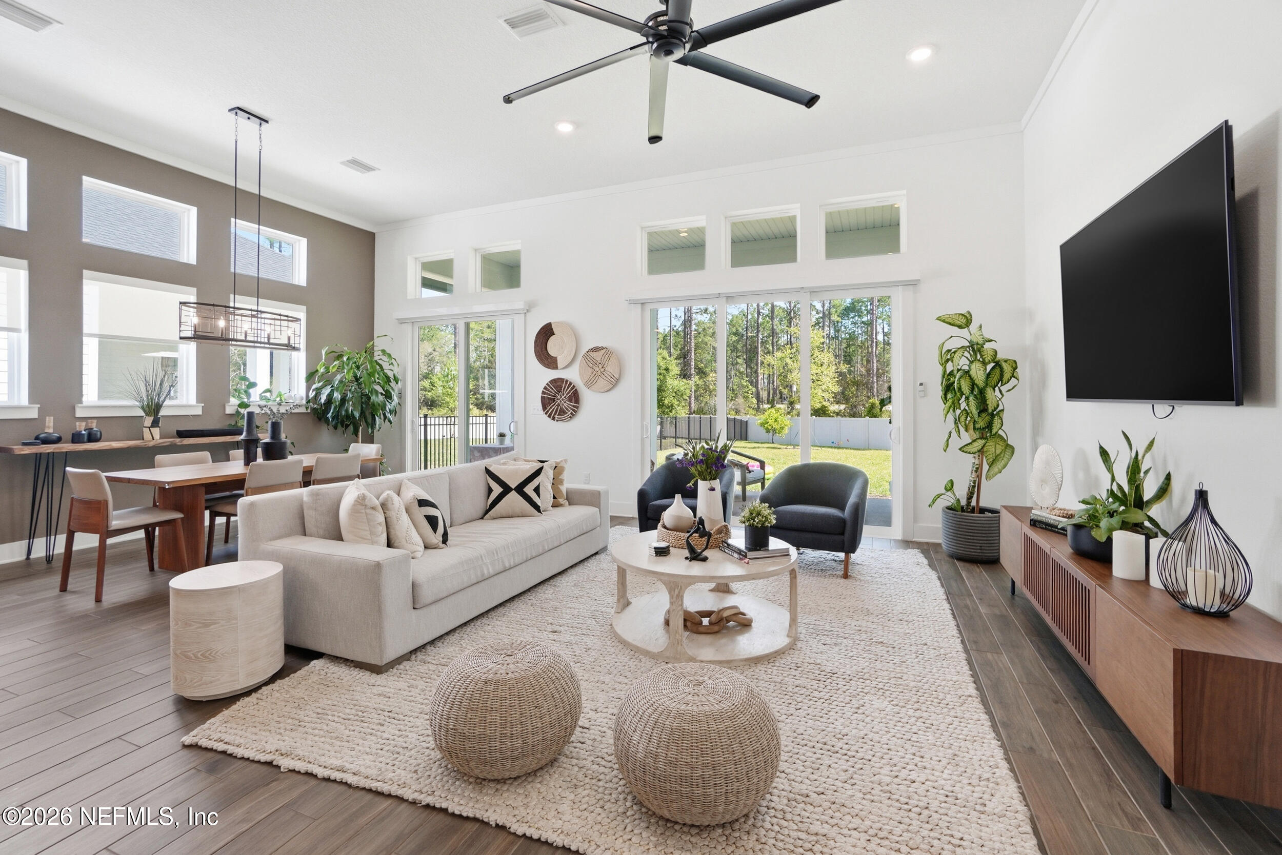 728 Navigators Road St. Johns, FL 32259 - Photo 13 of 38 a living room with furniture flat screen tv and a large window