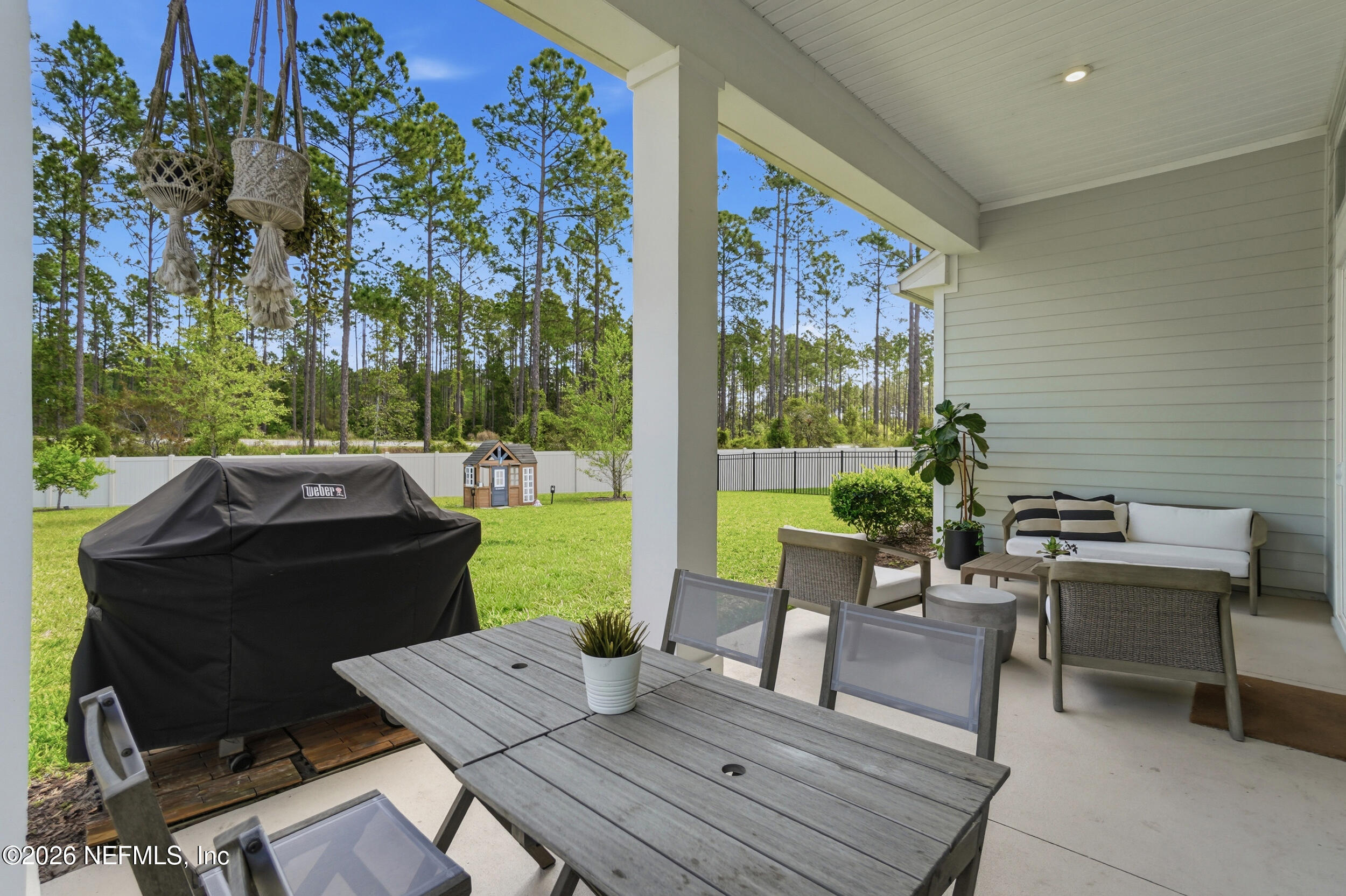 728 Navigators Road St. Johns, FL 32259 - Photo 27 of 38 a view of a patio with a dining table and chairs