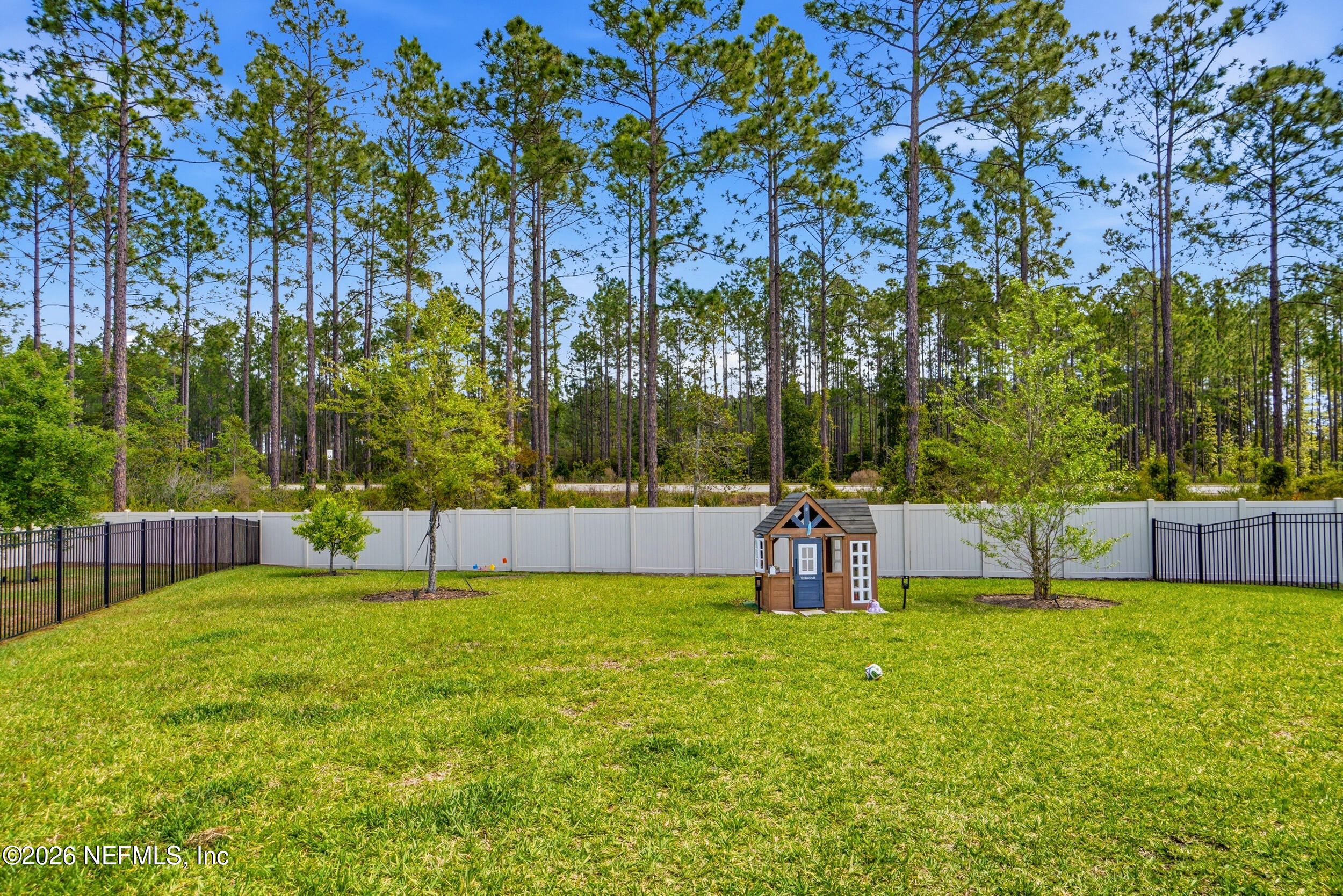 728 Navigators Road St. Johns, FL 32259 - Photo 28 of 38 a view of swimming pool with a bench and trees in the background