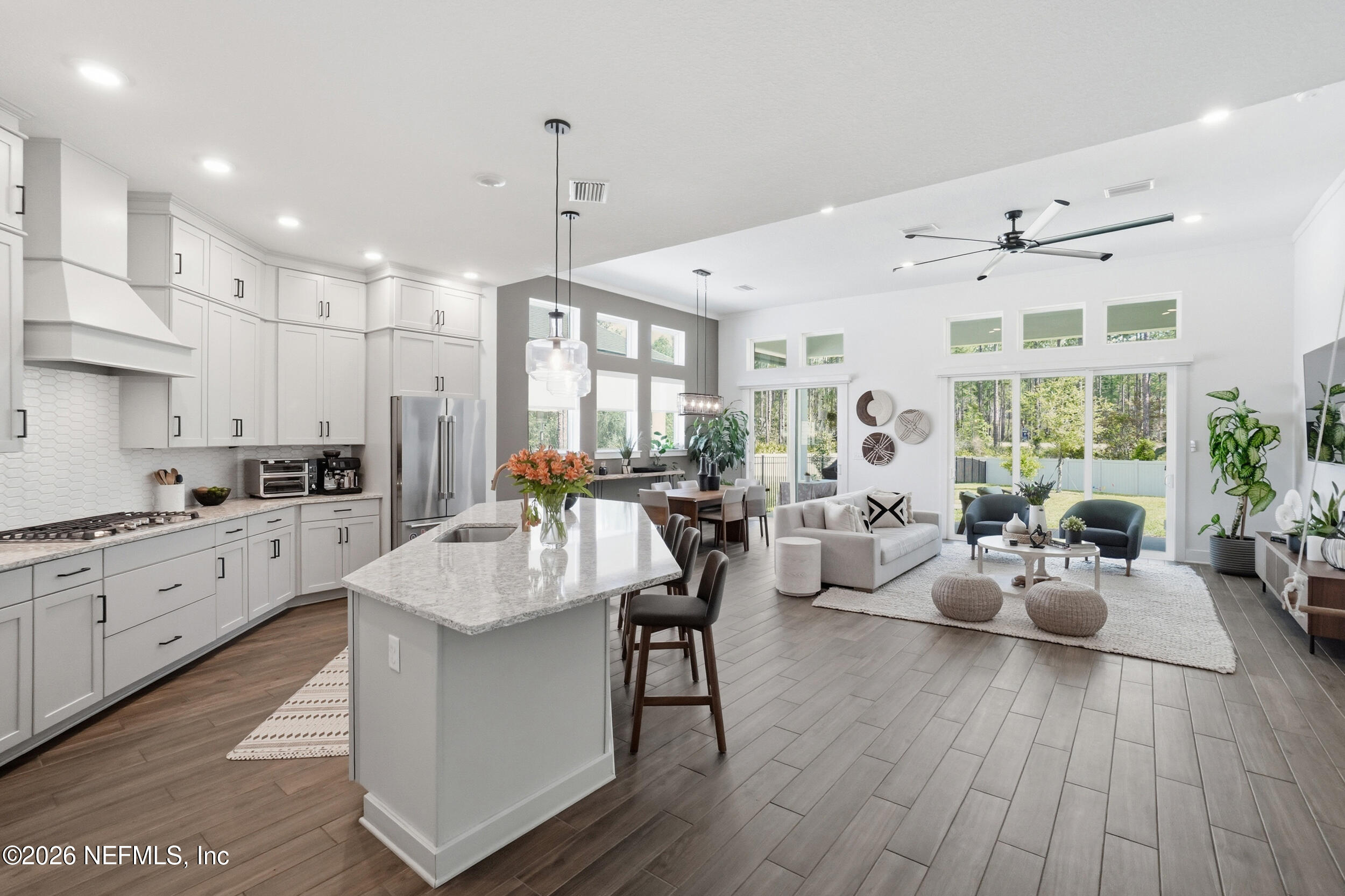 728 Navigators Road St. Johns, FL 32259 - Photo 6 of 38 a large kitchen with kitchen island a large counter space a sink stainless steel appliances and cabinets