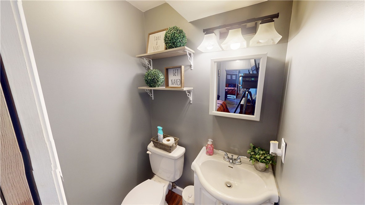 8 Chestnut Street Danville, IL 61832 - Photo 13 of 19 a bathroom with a sink mirror and toilet