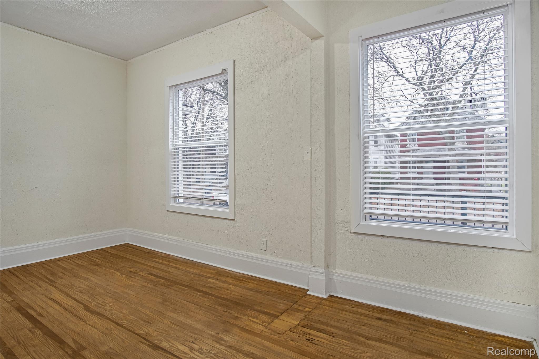 427 Melbourne Street Detroit, MI 48202 - Photo 16 of 29 Empty room featuring wood finished floors and a textured wall
