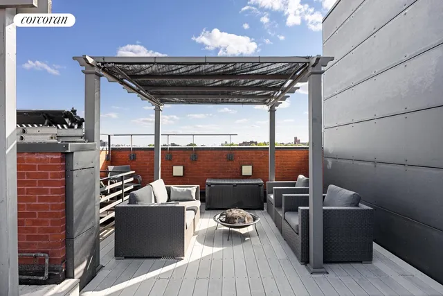 a view of a patio with a table chairs and barbeque
