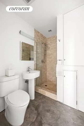 a bathroom with a sink a toilet and shower