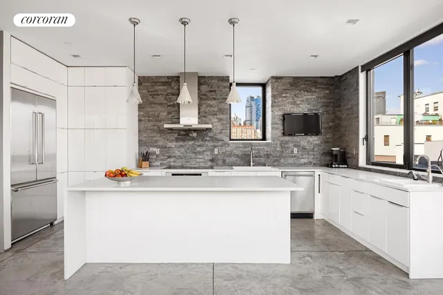 a large kitchen with a table and chairs