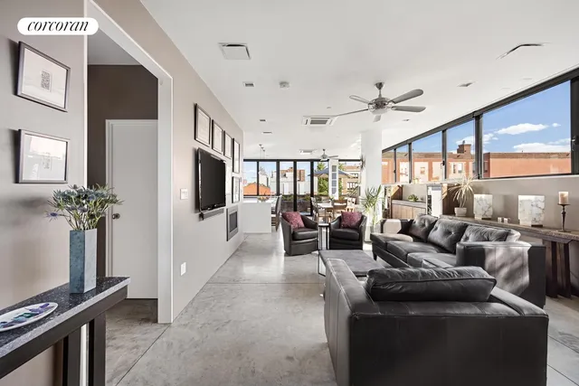 a living room with fireplace furniture and a flat screen tv