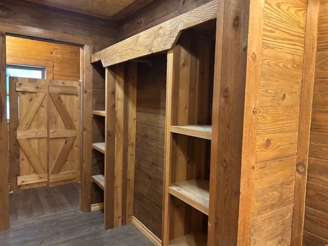 a bathroom with a glass door shower and vanity
