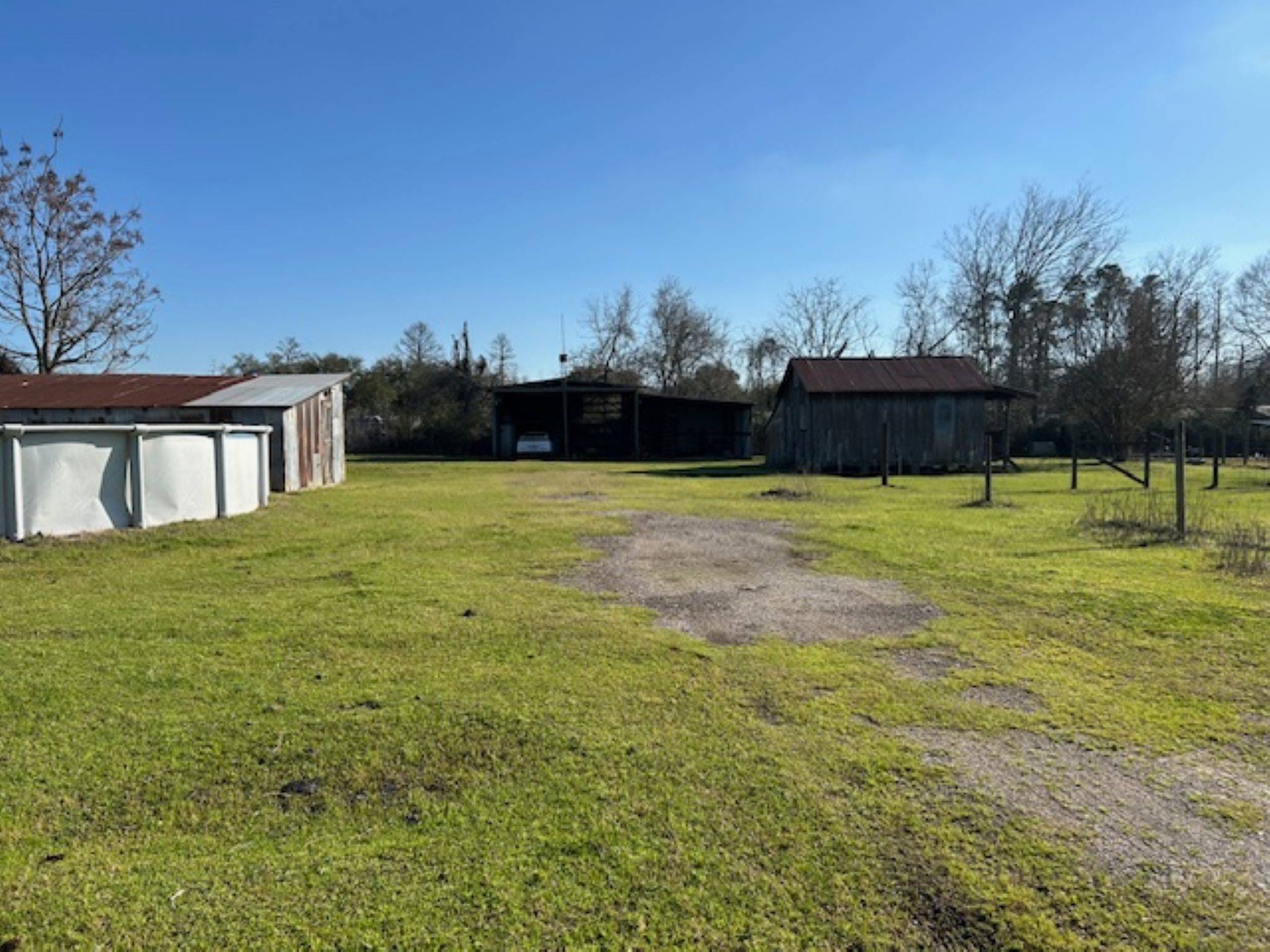 34743 Betka Road Waller, TX 77484 - Photo 5 of 20 a view of swimming pool with lawn chairs and wooden fence