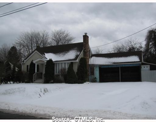 a front view of house with a garden