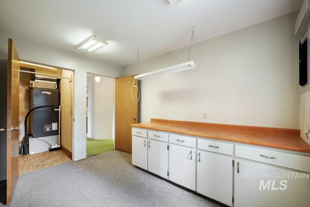 409 N Parkway Uniontown, WA 99179 - Photo 13 of 30 Kitchen with white cabinetry, light countertops, and open shelves