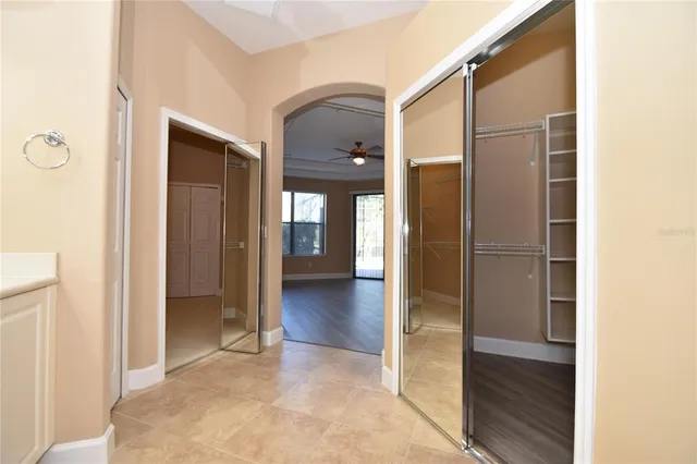 a large kitchen with stainless steel appliances kitchen island a large counter top and a refrigerator