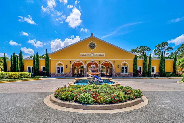 an aerial view of a house with a yard and lake view