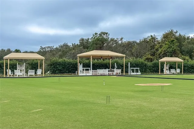 a view of a field with chairs