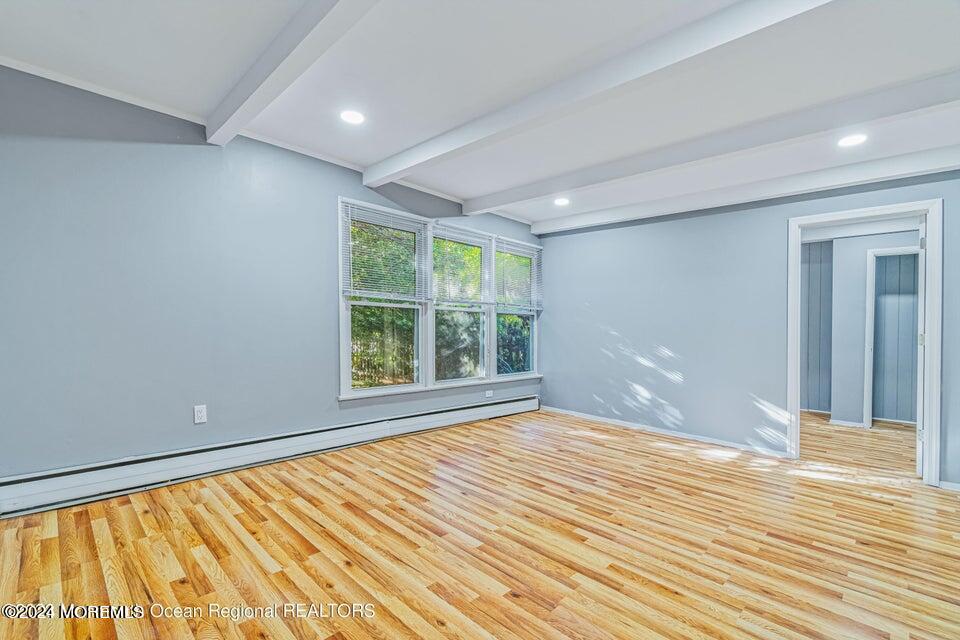 1 Dolphin Way Waretown, NJ 08758 - Photo 7 of 15 a view of an empty room with wooden floor and a window