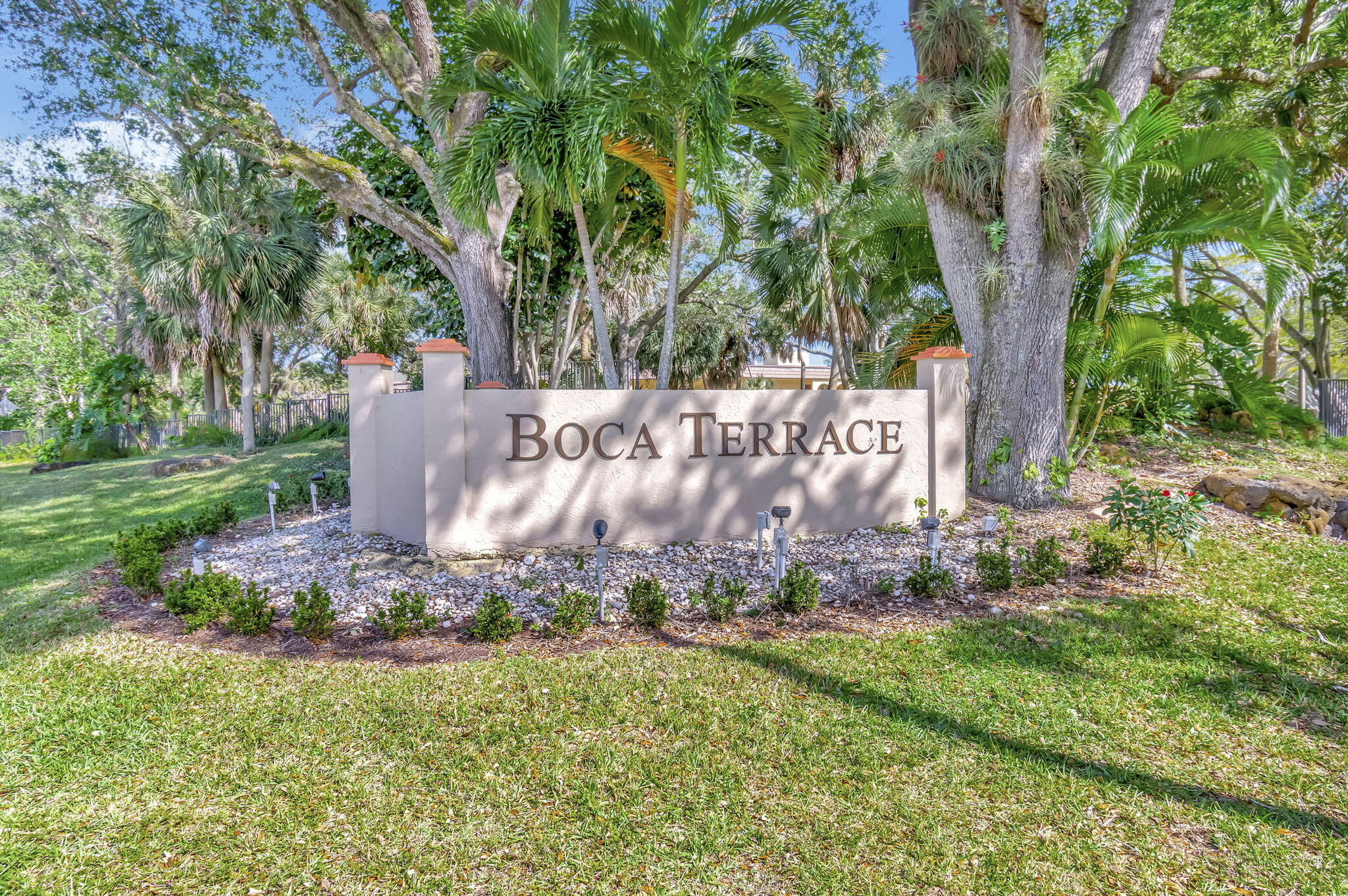 836 Southwest 9th St Circle, Unit 103 Boca Raton, FL 33486 - Photo 54 of 54 a view of a garden with large trees