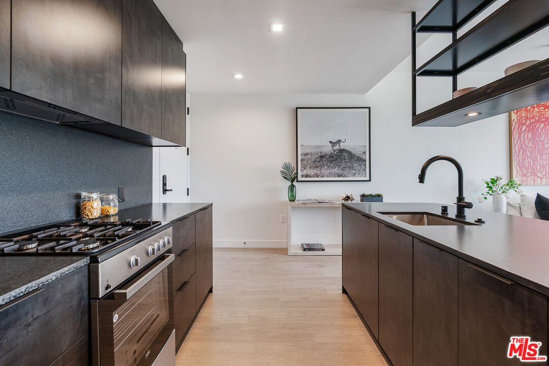10700 Tabor Street, Unit PH20 Los Angeles, CA 90034 - Photo 5 of 29 a kitchen with stainless steel appliances a sink stove and cabinets