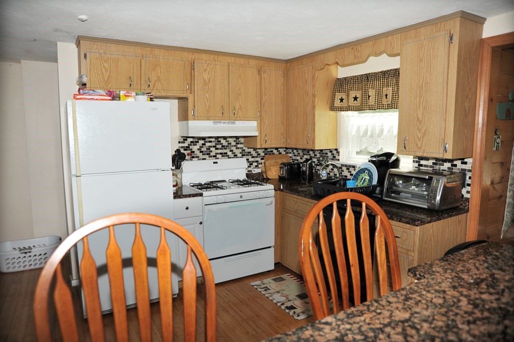 37 Raechel Road, Unit 37 Randolph, MA 02368 - Photo 6 of 15 a kitchen with a refrigerator a stove a sink and a microwave