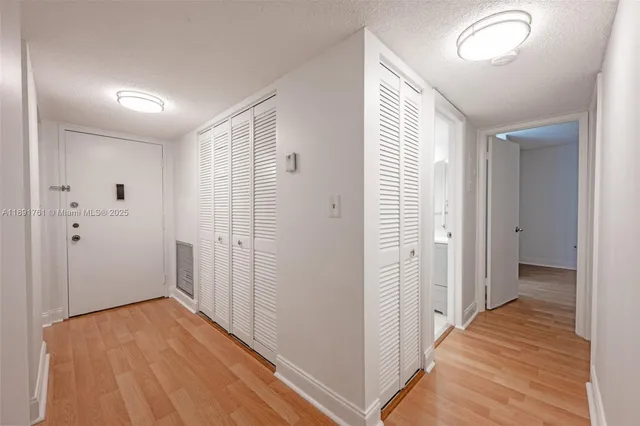 a view of a room with wooden floor and windows