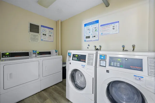 a utility room with cabinets dryer and washer