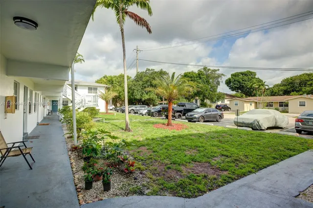 a view of a house with a yard porch and sitting area