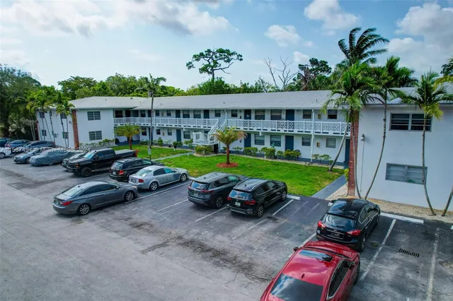 a view of a swimming pool and lounge chairs in back yard of the house