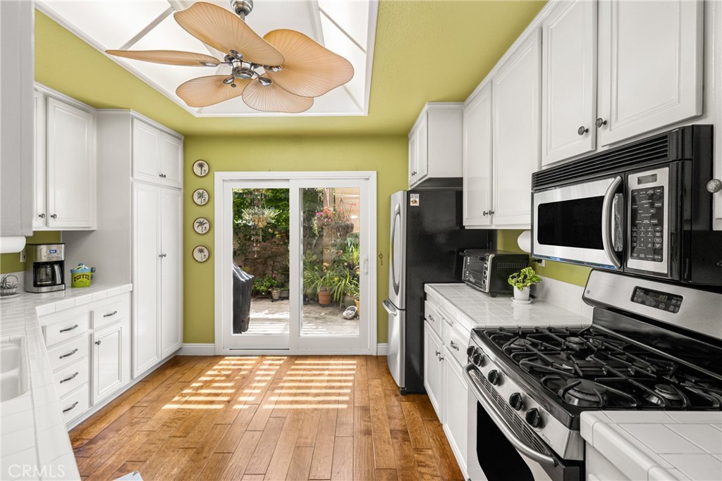 2370 Tryall Tustin, CA 92782 - Photo 10 of 36 a kitchen with stainless steel appliances granite countertop a stove and a refrigerator