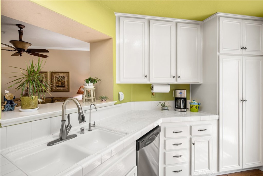 2370 Tryall Tustin, CA 92782 - Photo 12 of 36 a kitchen with granite countertop a sink a stove and cabinets