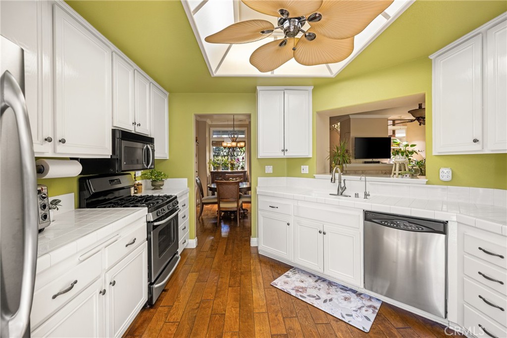 2370 Tryall Tustin, CA 92782 - Photo 13 of 36 a kitchen with stainless steel appliances a sink stove and refrigerator
