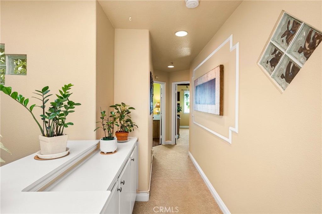 2370 Tryall Tustin, CA 92782 - Photo 16 of 36 a hallway with table and chairs