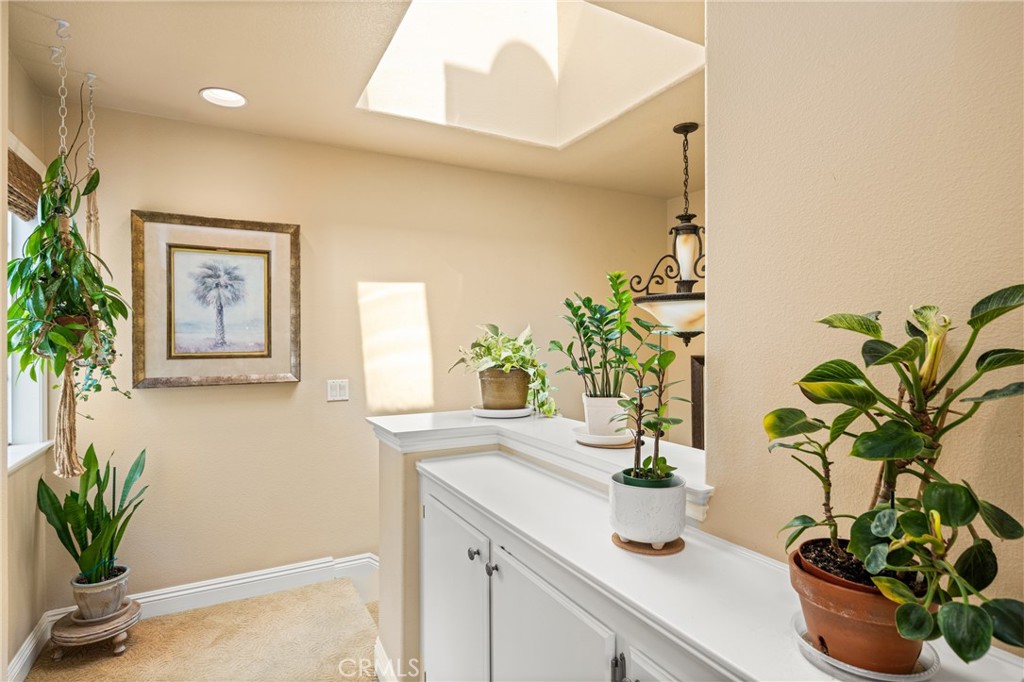 2370 Tryall Tustin, CA 92782 - Photo 17 of 36 a vase of flowers sitting on a table with a potted plant