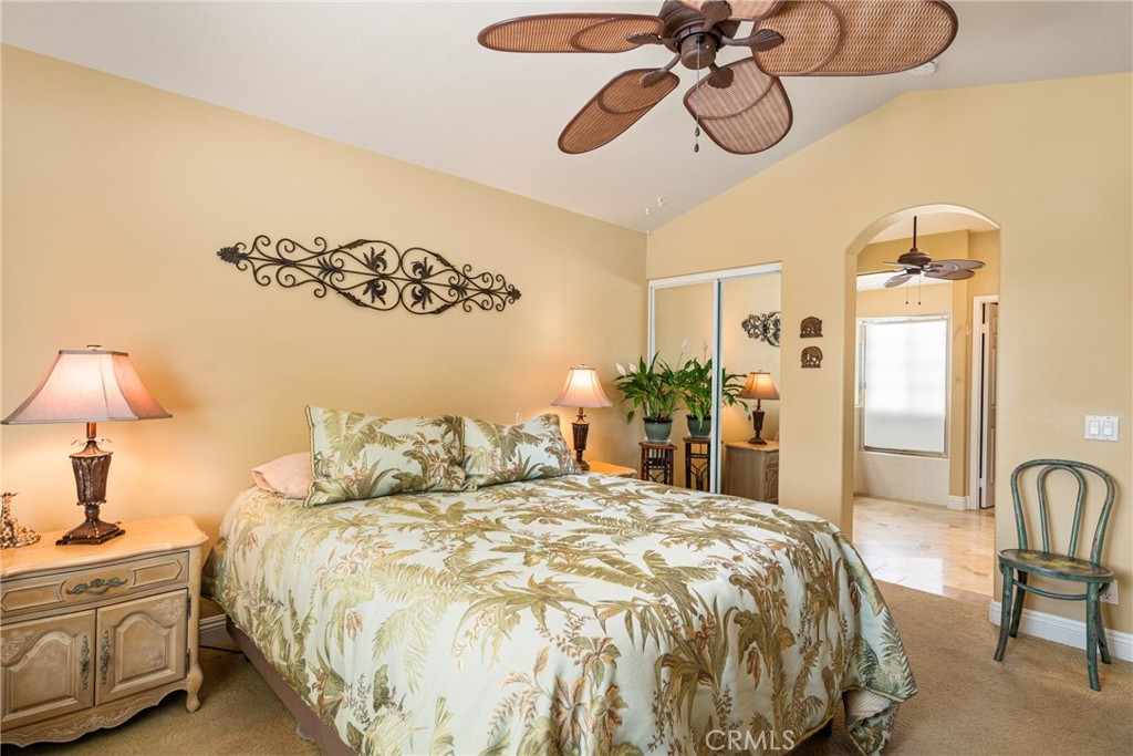 2370 Tryall Tustin, CA 92782 - Photo 19 of 36 a bedroom with a bed and a chandelier