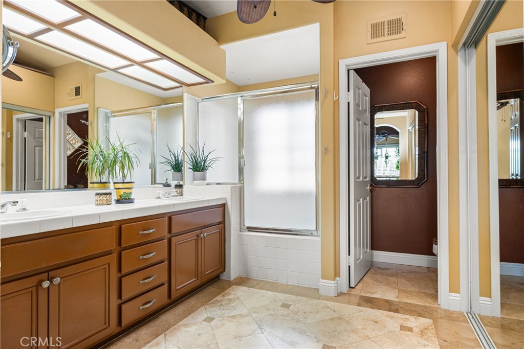 2370 Tryall Tustin, CA 92782 - Photo 20 of 36 a bathroom with a double vanity sink and a mirror