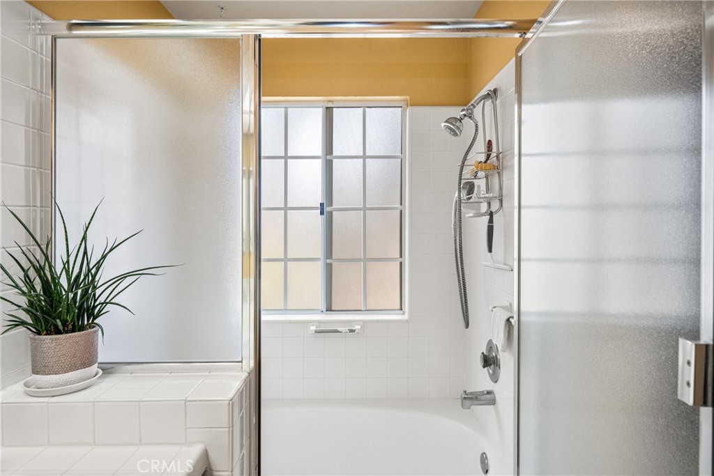 2370 Tryall Tustin, CA 92782 - Photo 21 of 36 a bathroom with a shower and a glass door