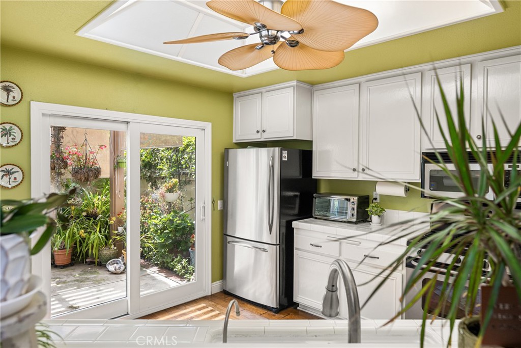 2370 Tryall Tustin, CA 92782 - Photo 9 of 36 a kitchen with stainless steel appliances a refrigerator a sink and cabinets