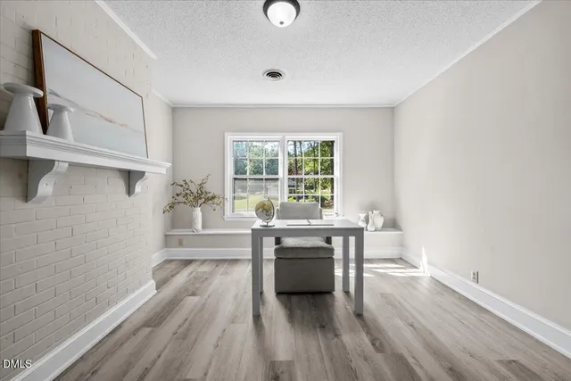 a kitchen with a wooden floor and a window