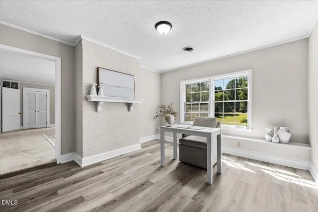 a view of a room with a window and wooden floor
