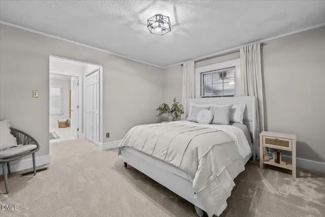 a bedroom with a bed and a chair