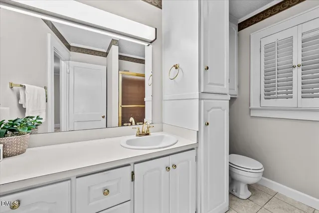 a bathroom with a granite countertop shower and a toilet