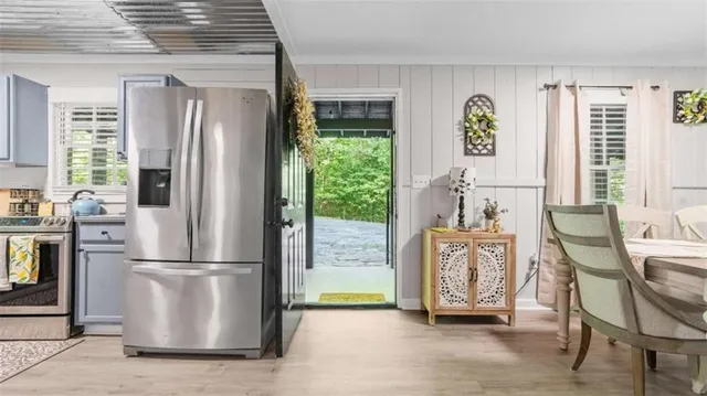 a view of kitchen with furniture and refrigerator