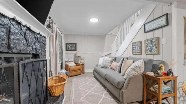 a living room with furniture and stairs