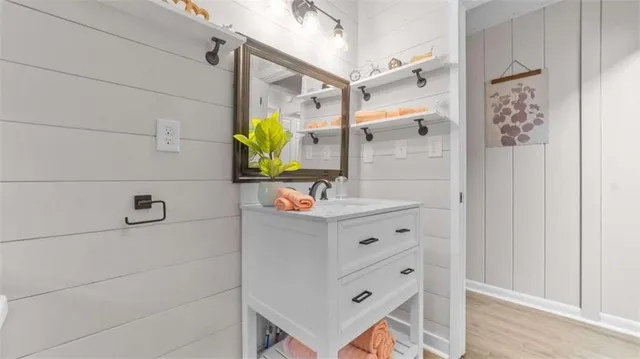 a bathroom with a bathtub sink vanity and mirror