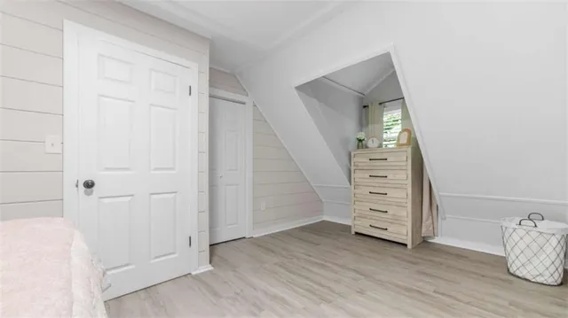 an empty room with furniture and wooden floor