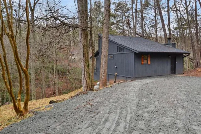 a backyard of a house with a large tree
