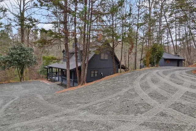 front view of a house with a yard and trees