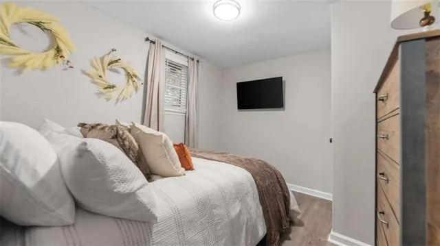 a bedroom with a bed and a flat screen tv