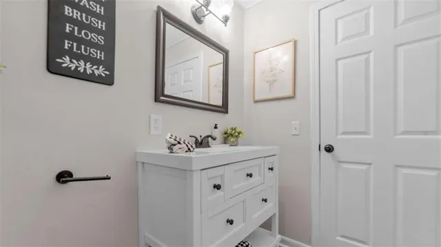 a bathroom with a sink mirror and vanity