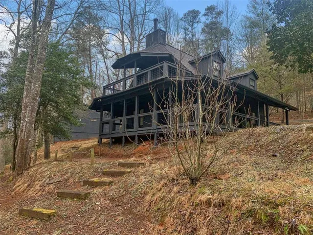 a view of a wooden house with a yard