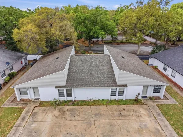 an aerial view of a house with a yard