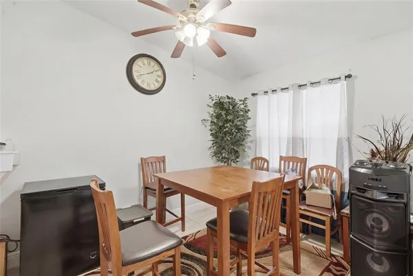 a view of a dining room with furniture and a chandelier